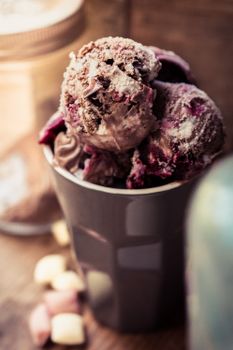 Close-up of berry chocolate ice cream in a cup, showcasing a rich and creamy texture.