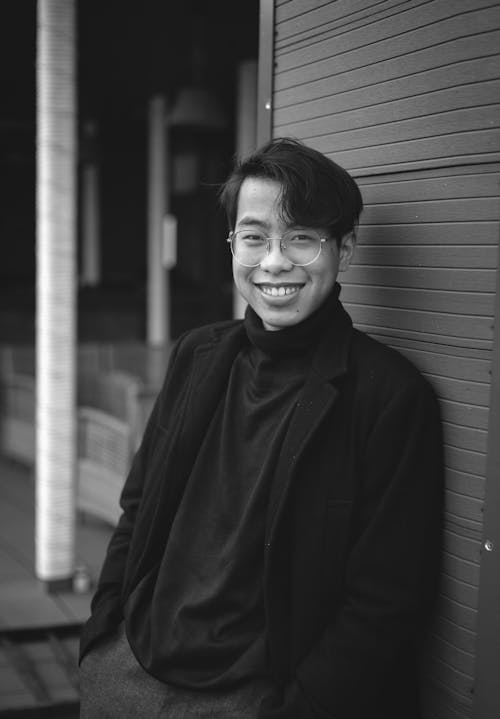 Grayscale Photo of a Man in Black Turtleneck Smiling