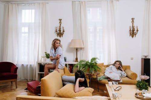 Free Women in Pajamas Sitting on the Sofa Stock Photo