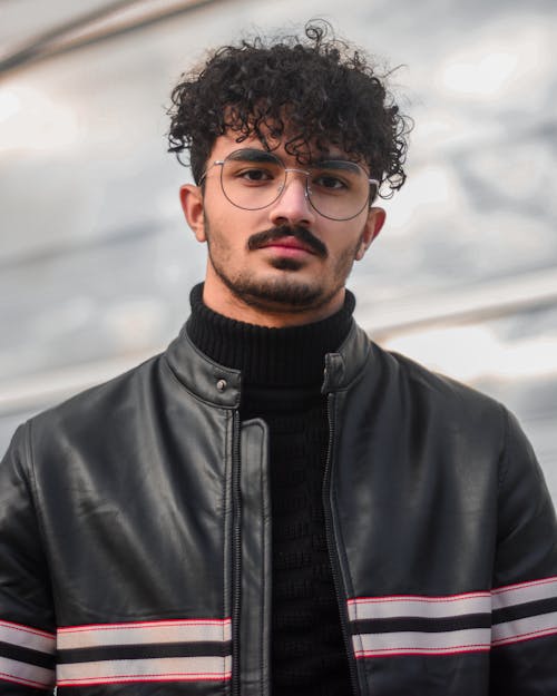 Man in Black Leather Jacket Wearing Black Framed Eyeglasses