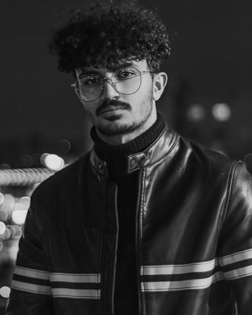 Grayscale Photo of Man in Black Leather Jacket