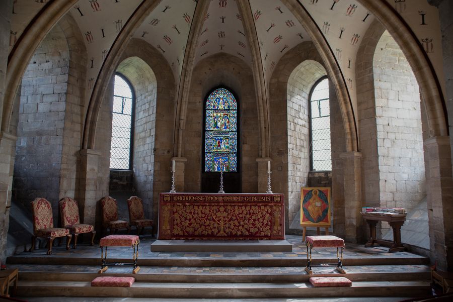 Gothic cathedral nave with stained glass and pews