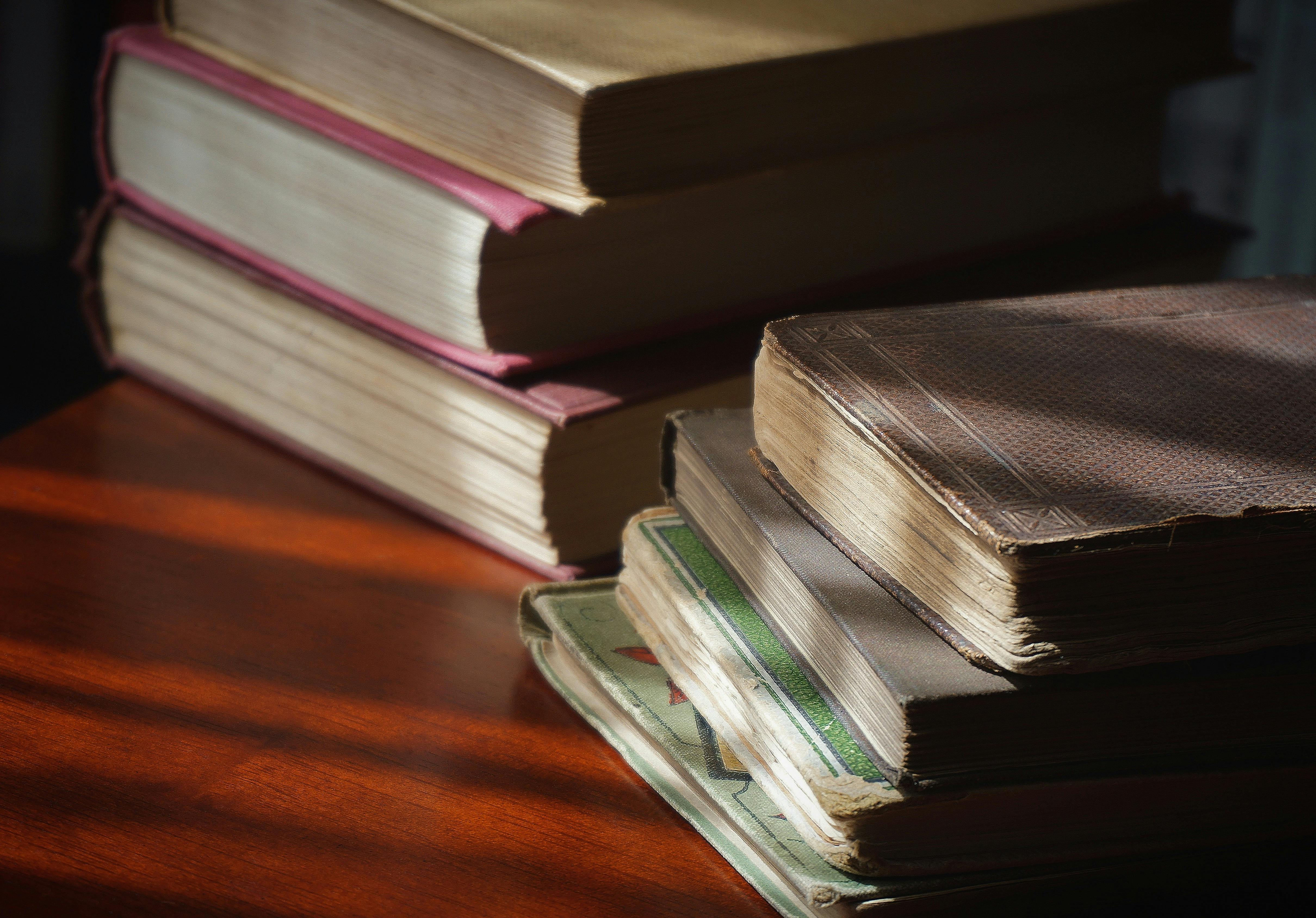 stack of economic books on desk