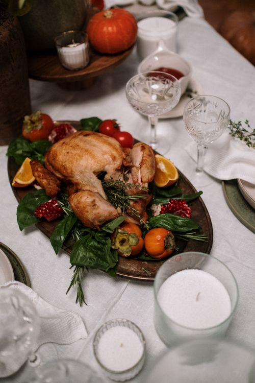 Free Mouthwatering Thanksgiving feast featuring roast turkey garnished with fresh vegetables and herbs. Stock Photo