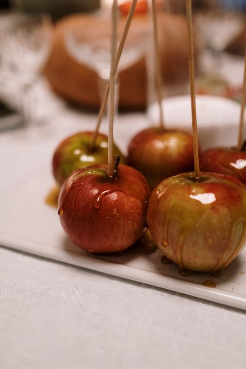 Free Close-up of caramel-coated apples on a stick, perfect for a sweet treat or dessert. Stock Photo