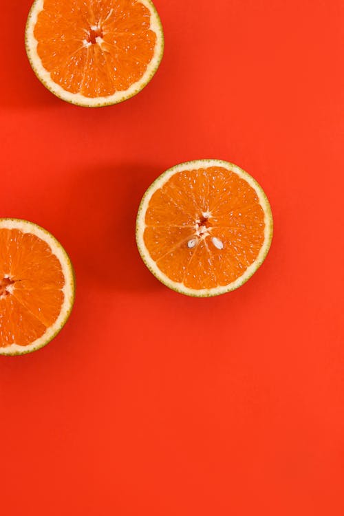 Sliced Orange on Red Surface