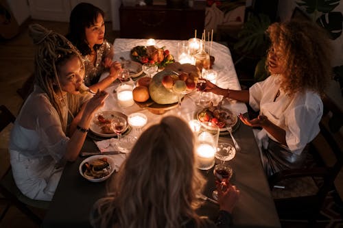 Free Women Eating with Candlelight on Table Stock Photo
