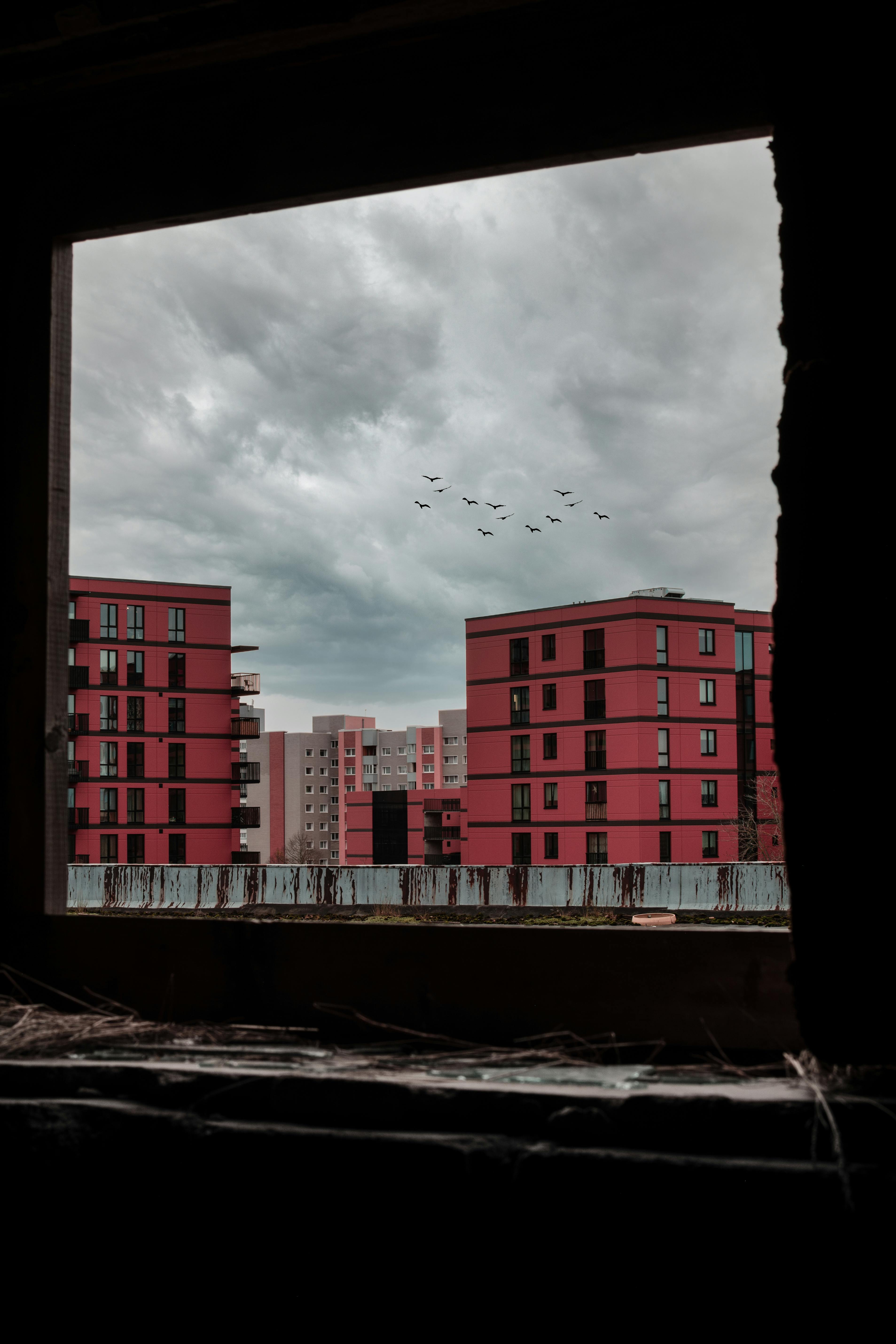 red and white concrete building under cloudy sky