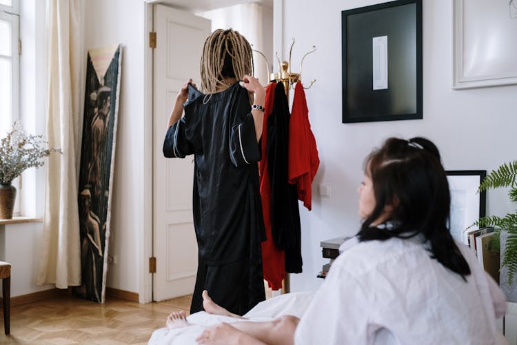 Women Trying Clothes In Room