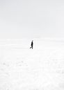 Lonely man in middle of snowy valley