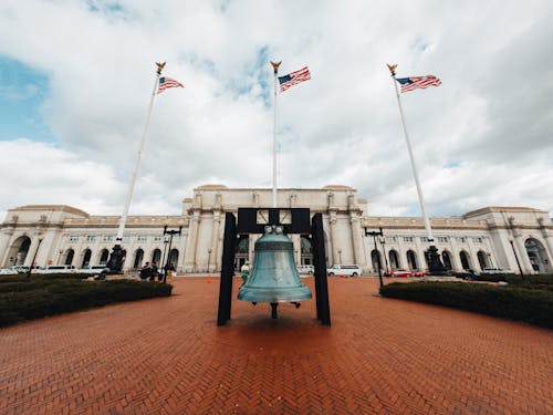 Free Old building facade against bell and flags in town Stock Photo