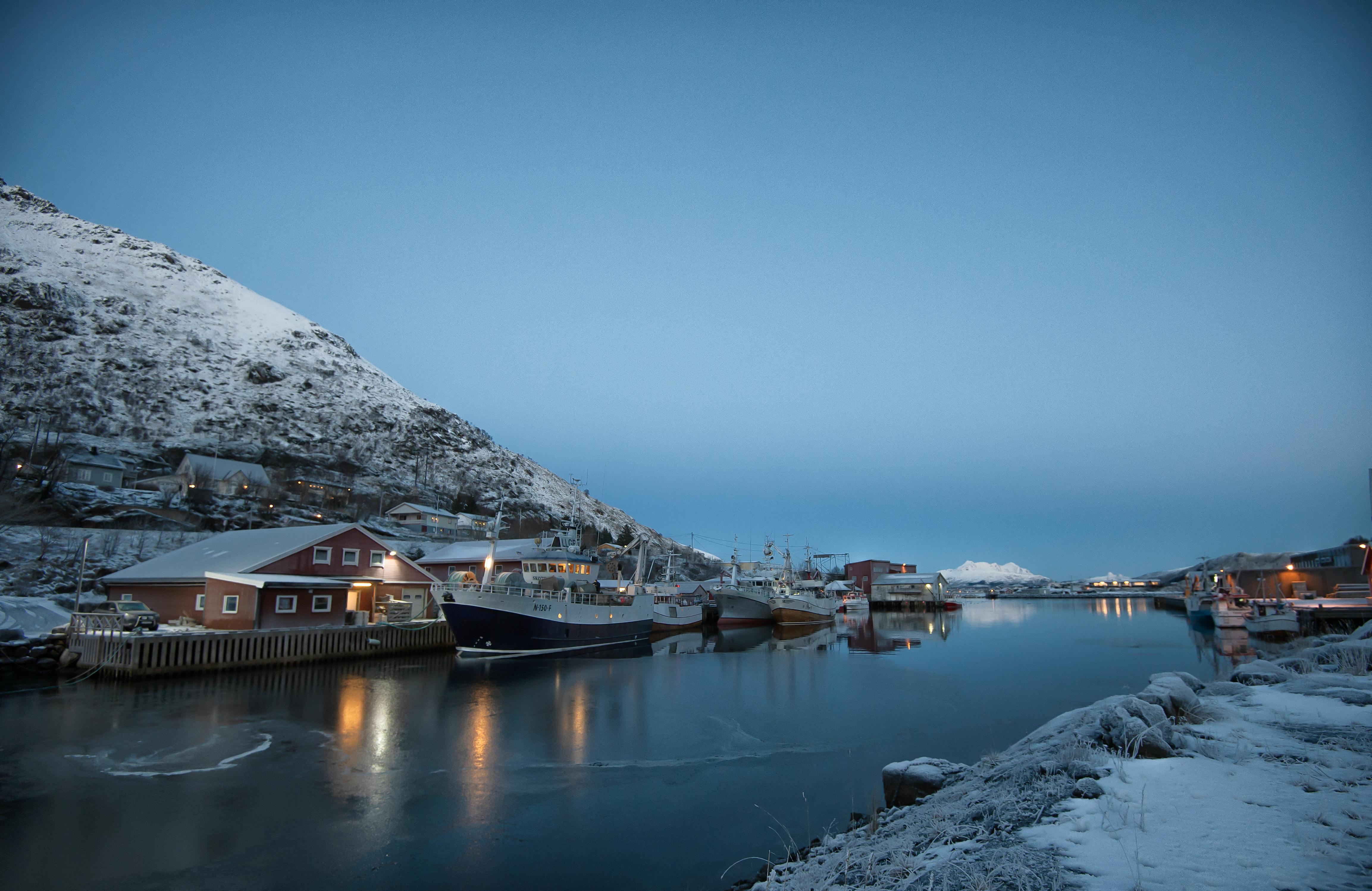 Prescription Goggle Inserts - Tranquil winter harbor scene with boats, snow-covered mountains, and icy water.