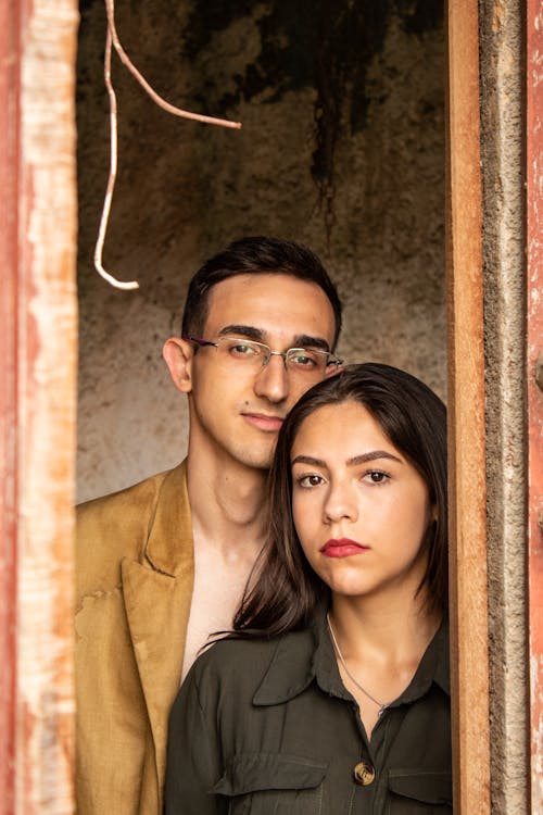 Portrait of a Young Couple Standing in the Window 