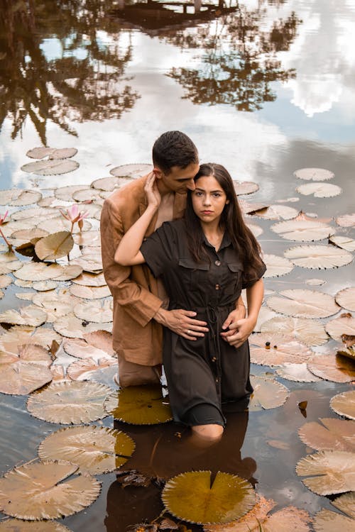 Young Couple Standing in the Pond and Hugging Each Other 