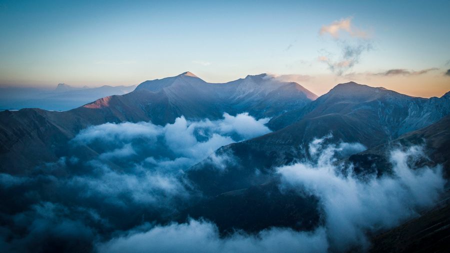 Mountain ridge above a sea of cloud at first light — photo by Vittorio Staffolani on Pexels