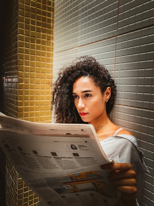 Free Woman Reading a Newspaper Stock Photo