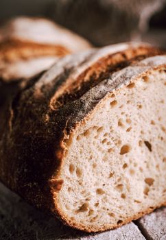 Warm close-up of a homemade rustic artisan bread loaf with a crispy crust perfect for breakfast.