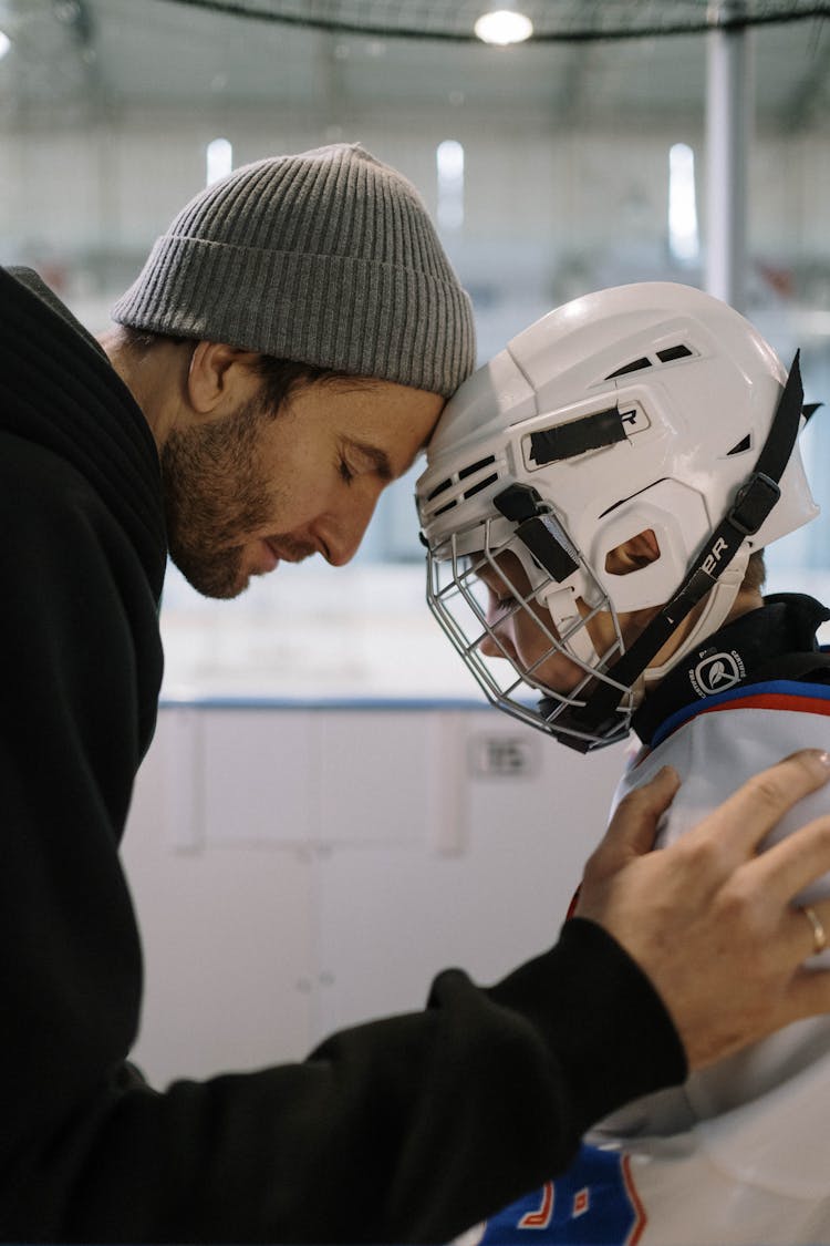 Man In Black Jacket And Boy Wearing White Helmet