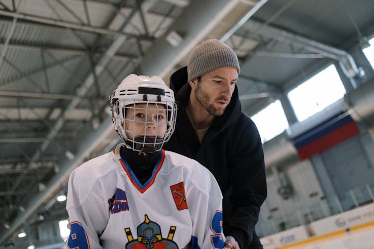 A Man Teaching Hockey To His Son