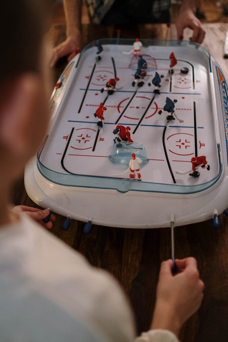 Kids Playing Tabletop Hockey Game