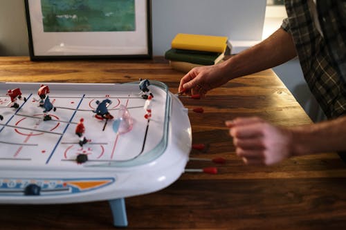 Close up of Man Playing Ice Hockey on Table