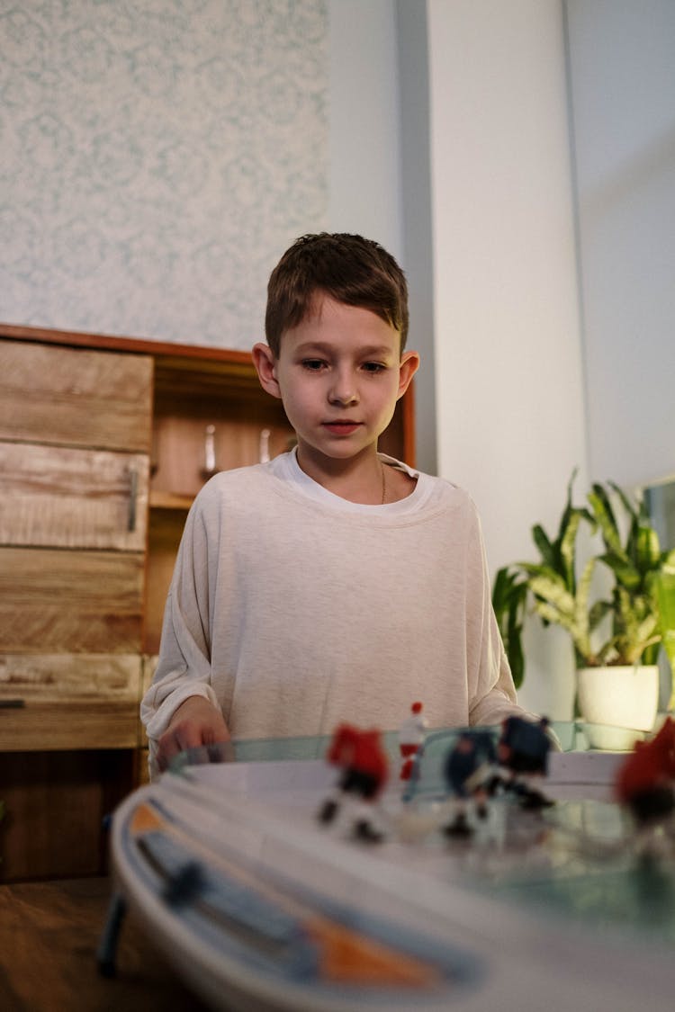 A Boy Near A Table Hockey