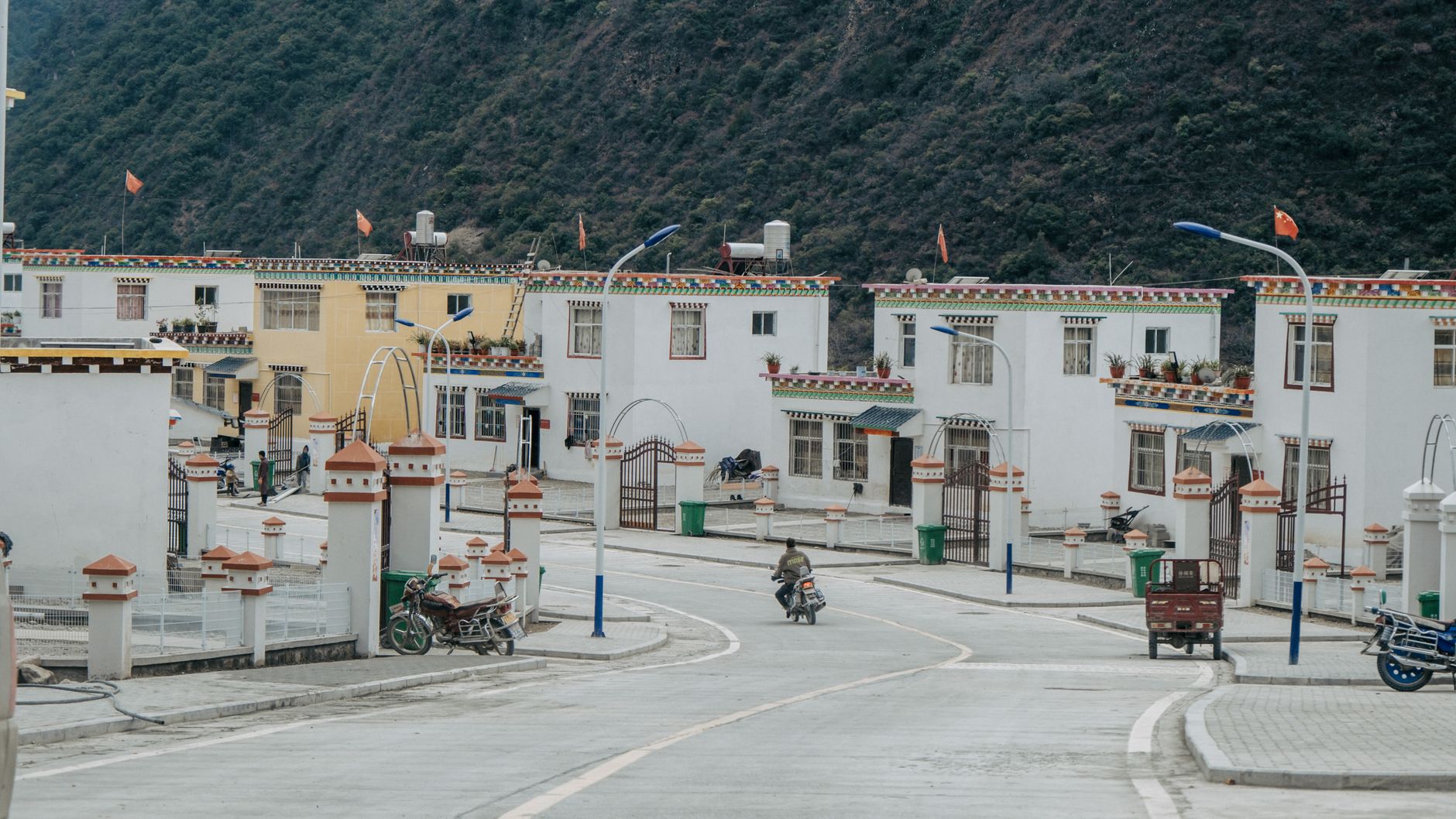 Picturesque scene of vibrant traditional village houses lining a quiet street, showcasing cultural architecture.