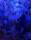 Woman in Blue and White Dress Standing on Blue and White Abstract Painting