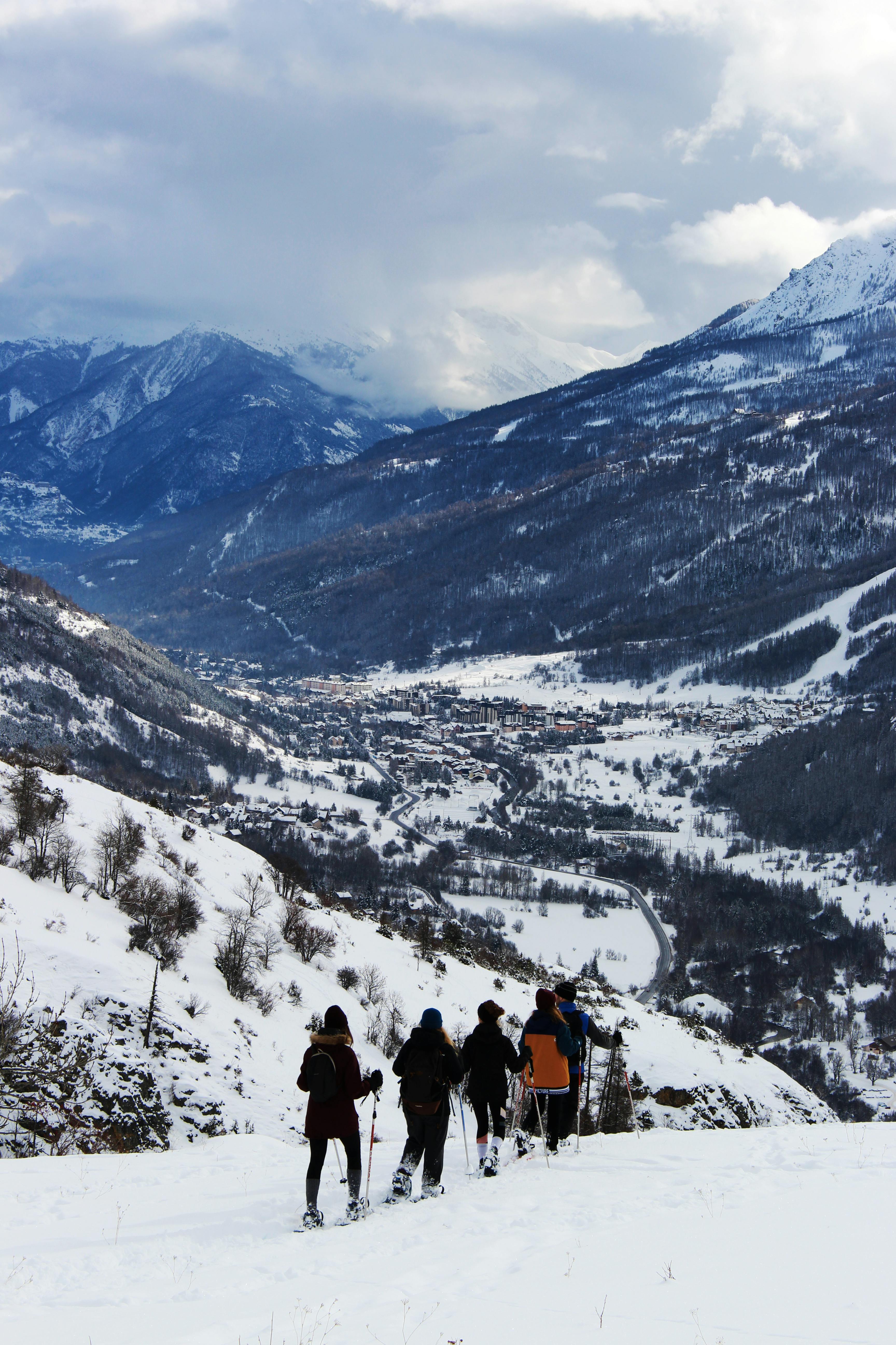 Prescription Goggle Inserts - A group of people skiing in high altitude snowy mountains, enjoying winter adventure.