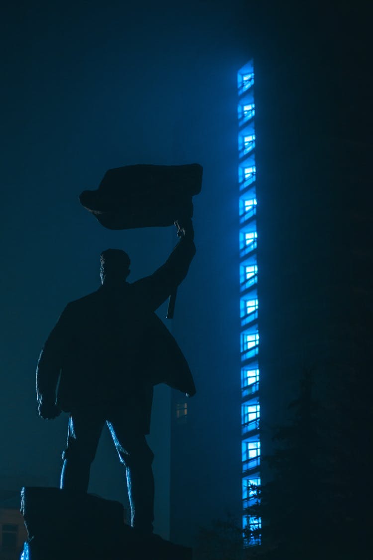 Dark Portrait Of A Man Illuminated By Blue Lights