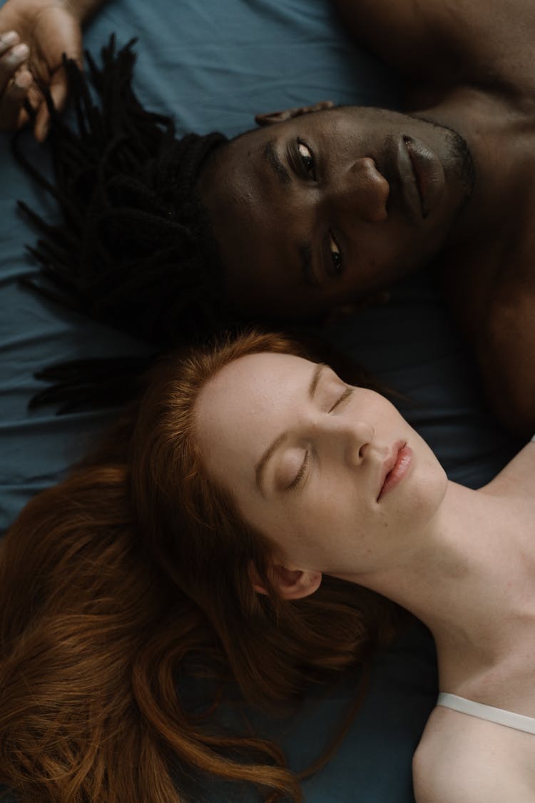 Man And Woman Lying Together In Bed