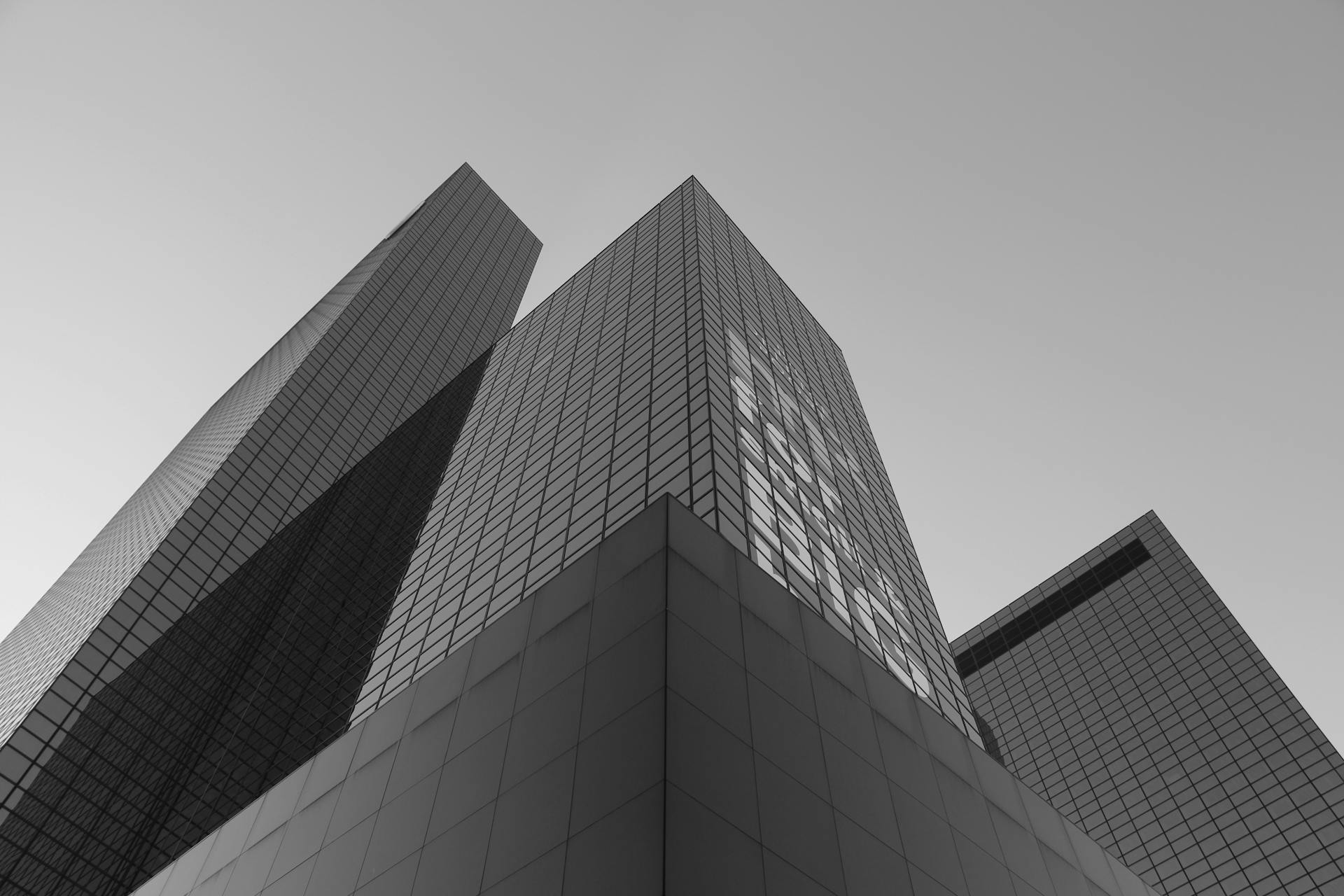 Monochrome shot of modern skyscrapers in Rotterdam with a low angle view.