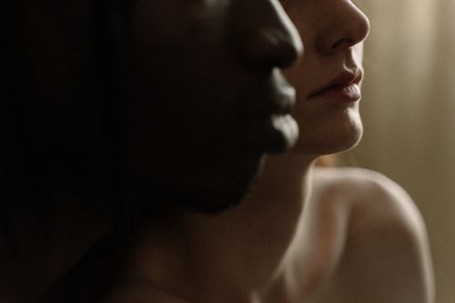 Free Artistic close-up of a diverse couple, showcasing tender connection. Stock Photo