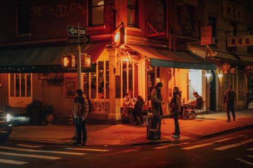 Free Cozy restaurant at night in New York City with people dining and socializing. Stock Photo