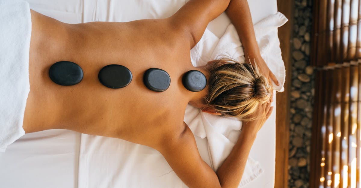 Person receiving a relaxing back massage in a spa setting.