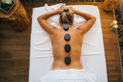 Free Stones on a Woman's Bare Back Stock Photo