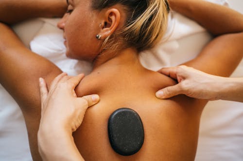 Free A Topless Woman Getting a Massage with Basalt at Her Back Stock Photo