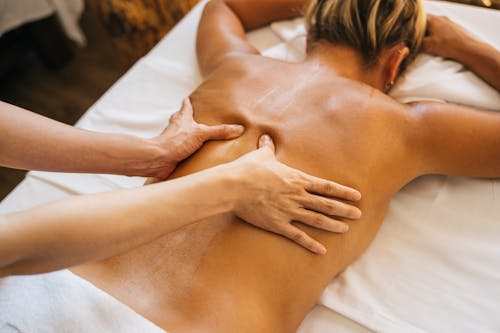 Free A Person Massaging a Client's Bare Back Stock Photo