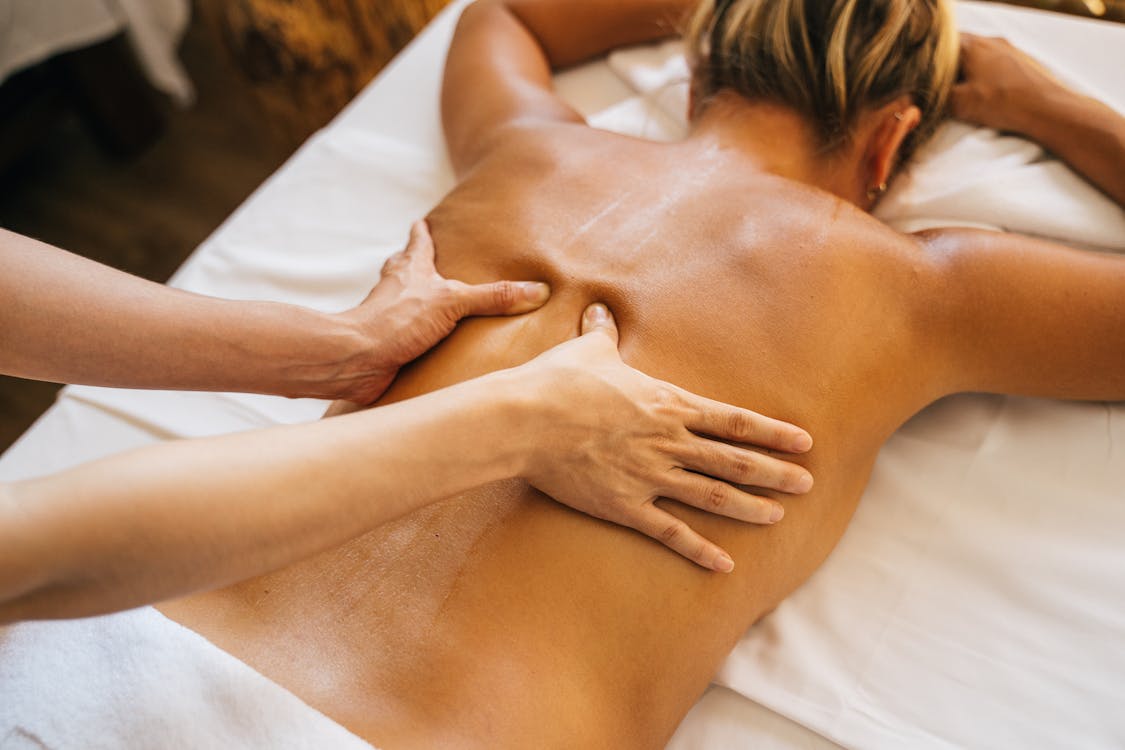 Woman getting a back massage on a massage table.