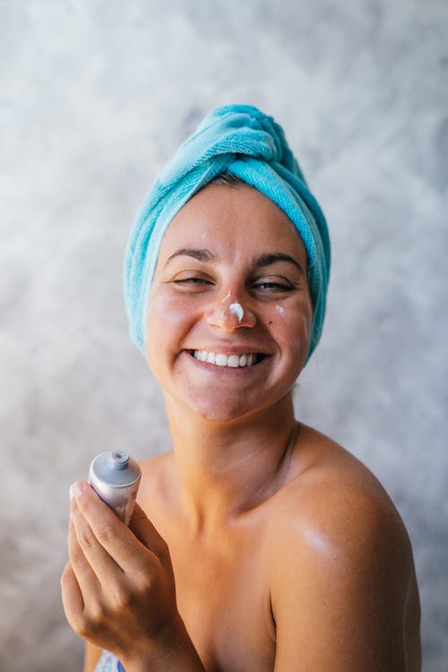 A Smiling Woman with Cream on Her Face