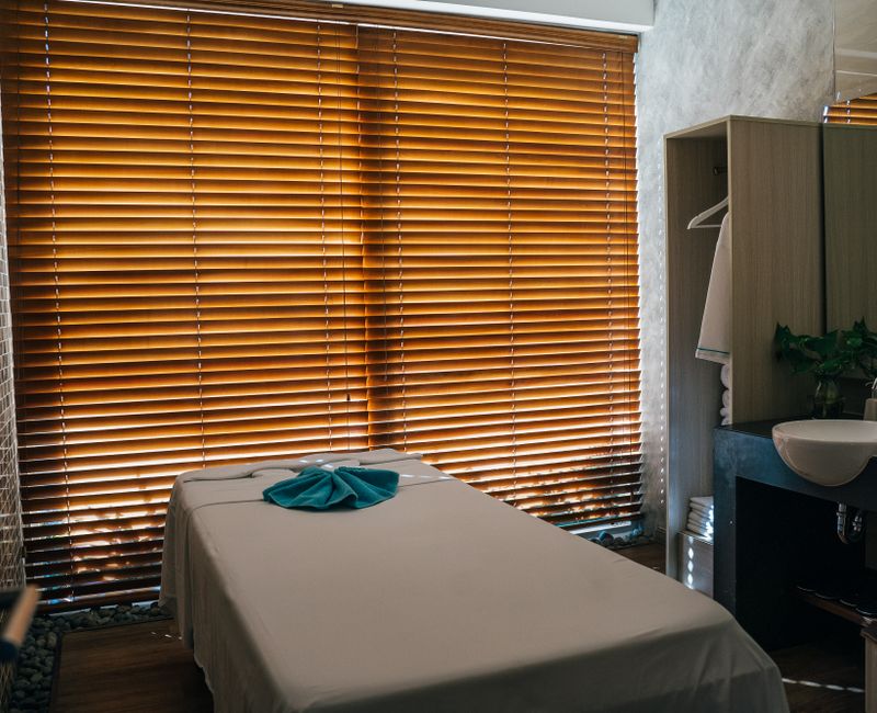 A serene hotel room set up for a mobile massage with soft lighting and fresh towels.