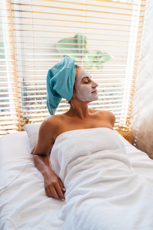 A Woman with Facial Mask Lying in Bed