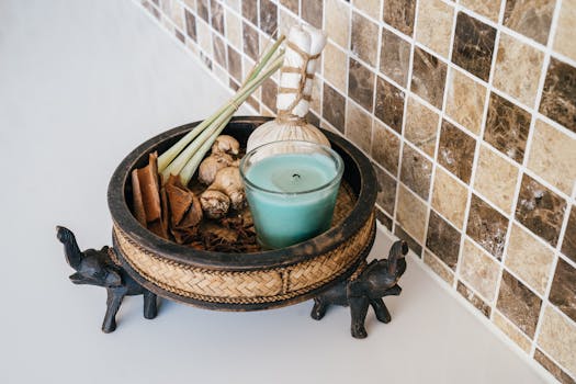 A soothing spa setup featuring a candle and herbs in a decorative bowl for tranquility.