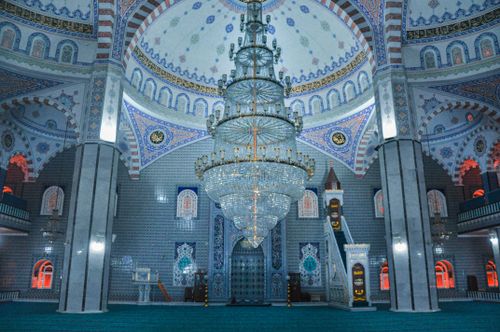 Free Elegant mosque interior in Turkey with ornate chandelier and detailed mosaics. Stock Photo