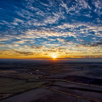Beautiful sunset with expansive cloudscape over fields in Caldwell, Idaho.