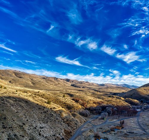 Free Discover the vast mountain landscape of Huntington, Oregon under a vibrant blue sky. Stock Photo