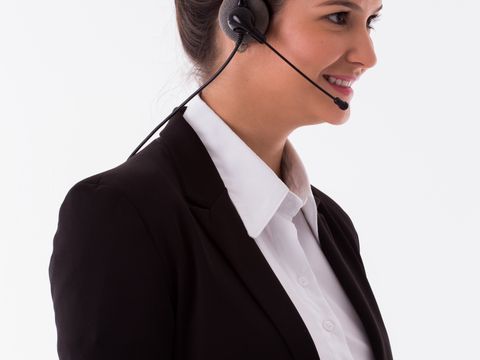 A customer service agent wearing a headset in an office