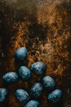 A collection of blue Easter eggs displayed against a rustic background, perfect for holiday themes.