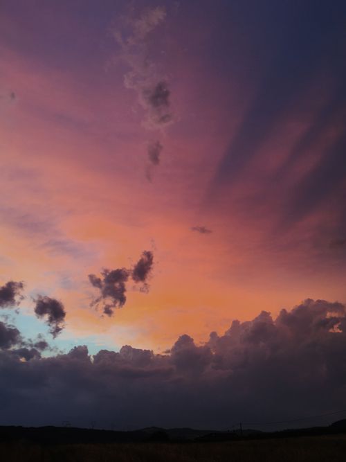 Free Stunning vibrant sunset with clouds creating a dramatic skyscape. Stock Photo