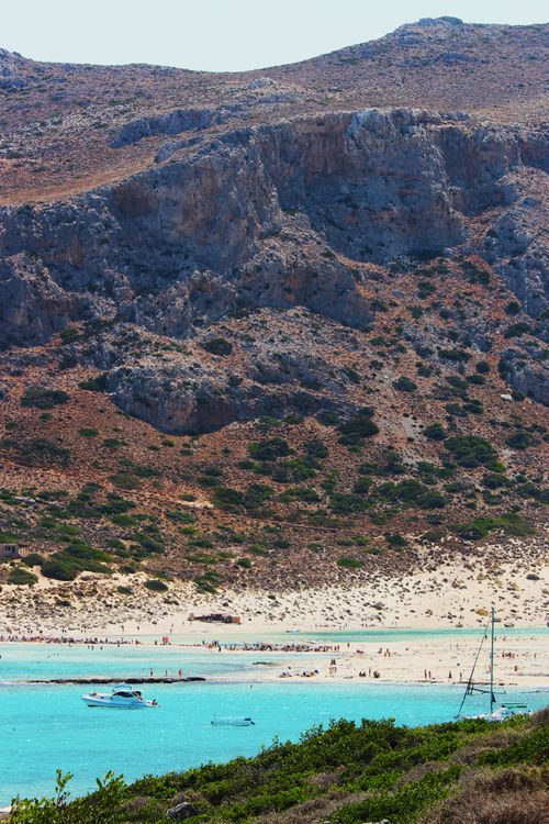 Free A stunning beach scene with turquoise waters, boats, and vibrant coastal landscape. Stock Photo